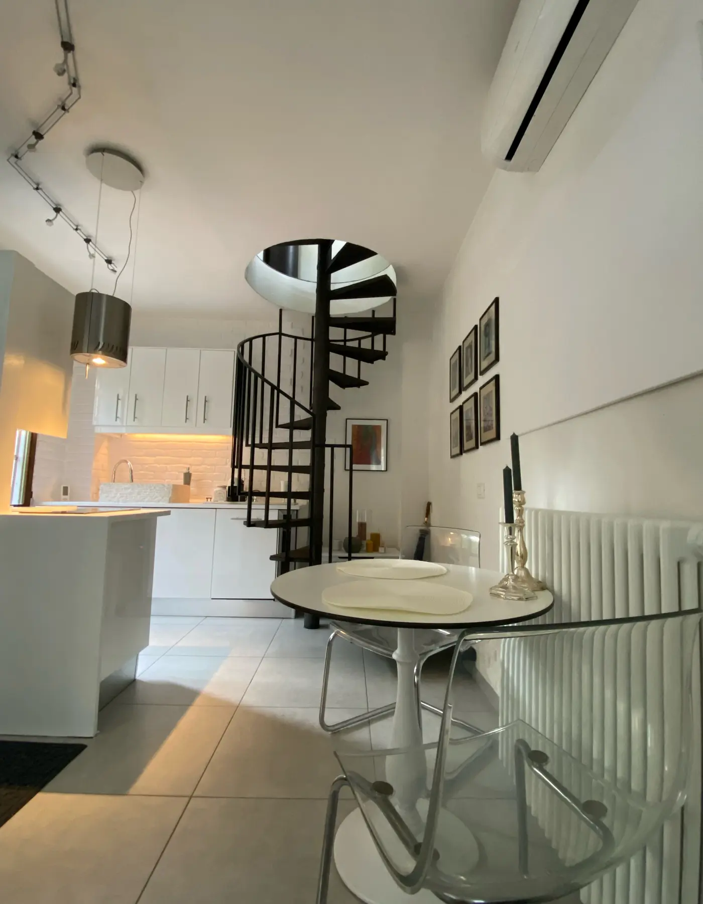 Interior of Secret Garden Stresa with spiral staircase and dining area