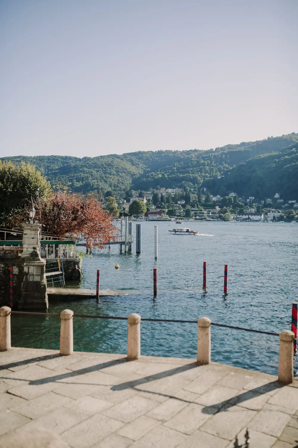 Lakeside terrace and moorings on Lake Maggiore with mountain views